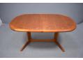 Teak dining table made in Denmark with oval top & 2 leaves.