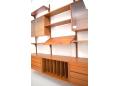 3 bay wall mounted system in teak designed by Poul Cadovius.
