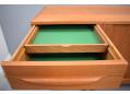 The top drawer of each set is divided by a green felt lined tray.