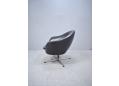 Low back swivel chair in black colour leather upholstery.