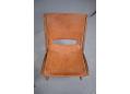 The chair retains the original tan colour leather