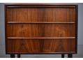 Equal depth drawers in compact rosewood chest.