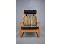 DAW Rainbow fabric upholstered armchair with light oak frame.