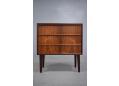 Bedside chest of 3 drawers in rosewood with lipped handles.