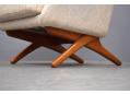 Oak scissor legs support the armchair giving it a lighter appearance.