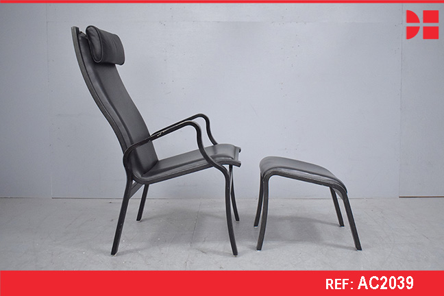 Modern Danish armchair with high back, matching stool and black leather upholstery
