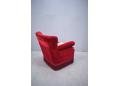 Red velour fabric upholstered armchair with low back rest.