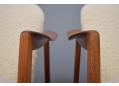 Vintage teak frame chairs raised on tapering legs 