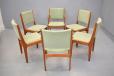 The stylish designed teak dining chairs offer comfort and elegance.