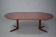 pedestal leg rosewood dining table extending with 2 extra leaves by Gudme