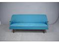 3 seat sofa made in Denmark with blue fabric & teak paws.