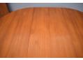 Teak dining table with round top that can be extended with 2 leaves.