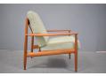 1952 design teak armchair model 128 with fabric cushions.