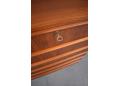 Lipped teak handles are fitted on the top of each drawer front.