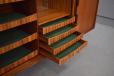 Zebra wood faced shallow drawers are lined with green felt