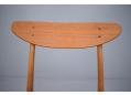 The gently curved teak back support showing superb patina.