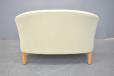 Danish design 2 seater curved frame sofa with cream upholstery