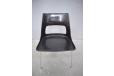 The moulded glass fibre and plastic chair seat is black and in great condition