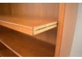 Adjustable shelving on hidden shelf supports for Danish bookcase in teak.