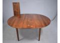 Danish rosewood table with circular top and 2 extra leaves to seat 8