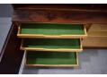 Each of the shallow drawers is lined with green felt