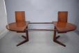 Easy to extend oval dining table with pedetal legs in vintage rosewood