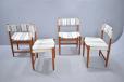 Side chairs with teak frames and striped fabric upholstery.