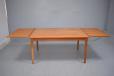 Midcentury teak dining table with hidden draw leaves  - view 9