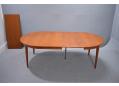 Vintage Danish dining table extends from round to 107 inch long oval.