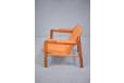 Tan leather fireplace chair with cherry wood frame designed by Edvard Kindt Larsen