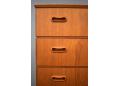 Each drawer is fitted with a pair of oblong shaped handles in teak.