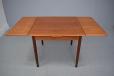 Midcentury teak dining table with two pull out draw leaves