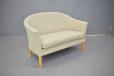 Small 2 seater curved back sofa in cream upholstery