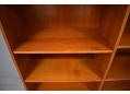 Adjustable shelving on hidden shelf supports for Danish bookcase in teak.