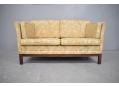 A compact and stylish sofa that is comfortable and elegant