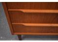 Lipped teak handles are fitted on the top of each drawer front.