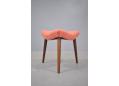 1950s foot stool with triangular seat and soft salmon tone upholstery