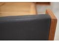 Black vinyl upholsterd foot board with teak sides