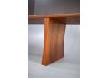 The sideboard stands on fixed sculptural legs in teak.