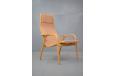Stylish armchair with original tan leather upholstery and laminated beech frame
