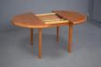 Extending vintage teak dining table with round top made in Denmark