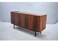 Free-standing short sideboard with rear panel in Honduran rosewood.