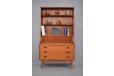A stylish vintage wall unit with slide out writing surface and bookcase storage 