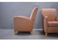 Salmon-pink fabric upholstered large club chair with high back.