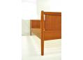 Frame with turned solid teak legs and open design.
