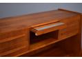 Hidden fold-away mirror on teak vanity unit.