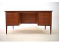 Midcentury teak desk with 8 drawers and raise edges.