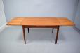 Danish design compact teak dining table with 2 pull out leaves
