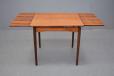 Midcentury teak dining table with two pull out draw leaves