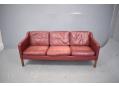 Box frame 3 seat settee with original leather and wooden legs.